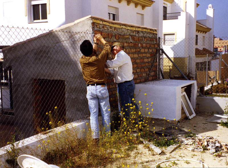 Nacho and Tom work on the fence.